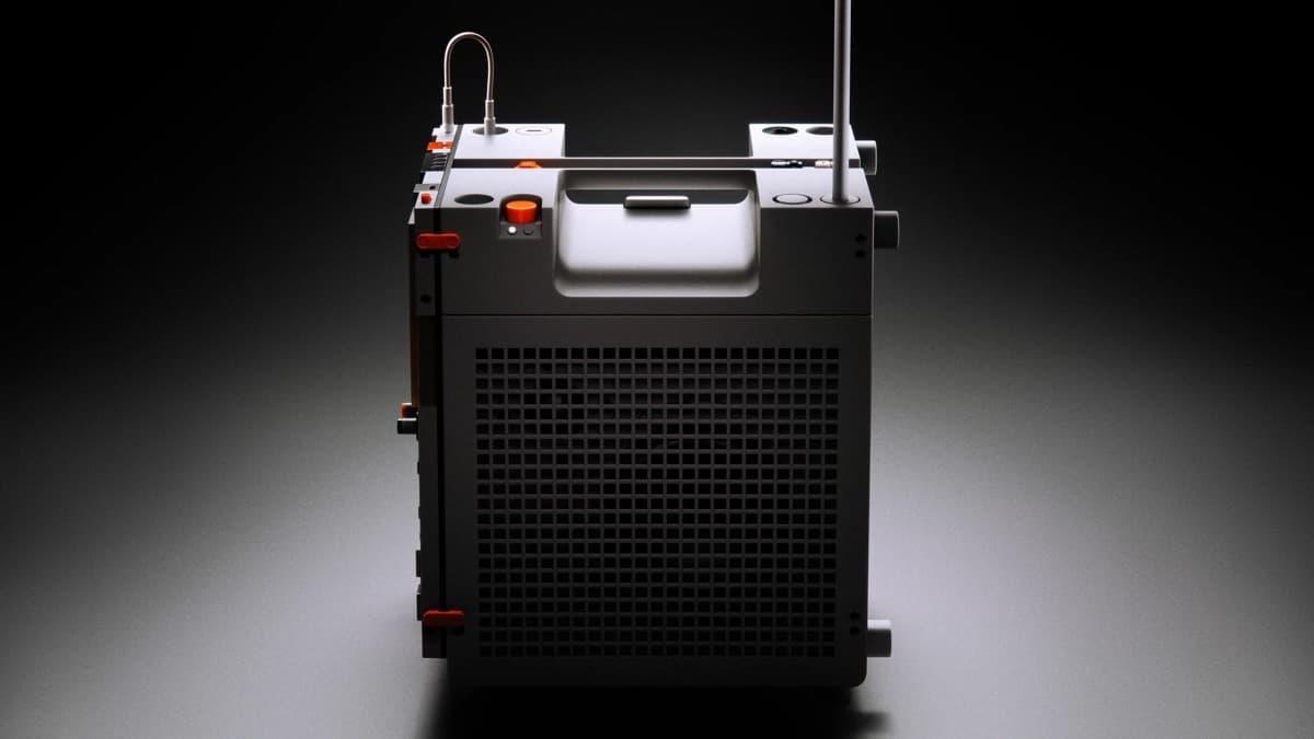 Teenage Engineering EP-35 K.O. AMP, a cube-shaped portable amplifier with speaker grille, antenna and orange controls, on a dark background